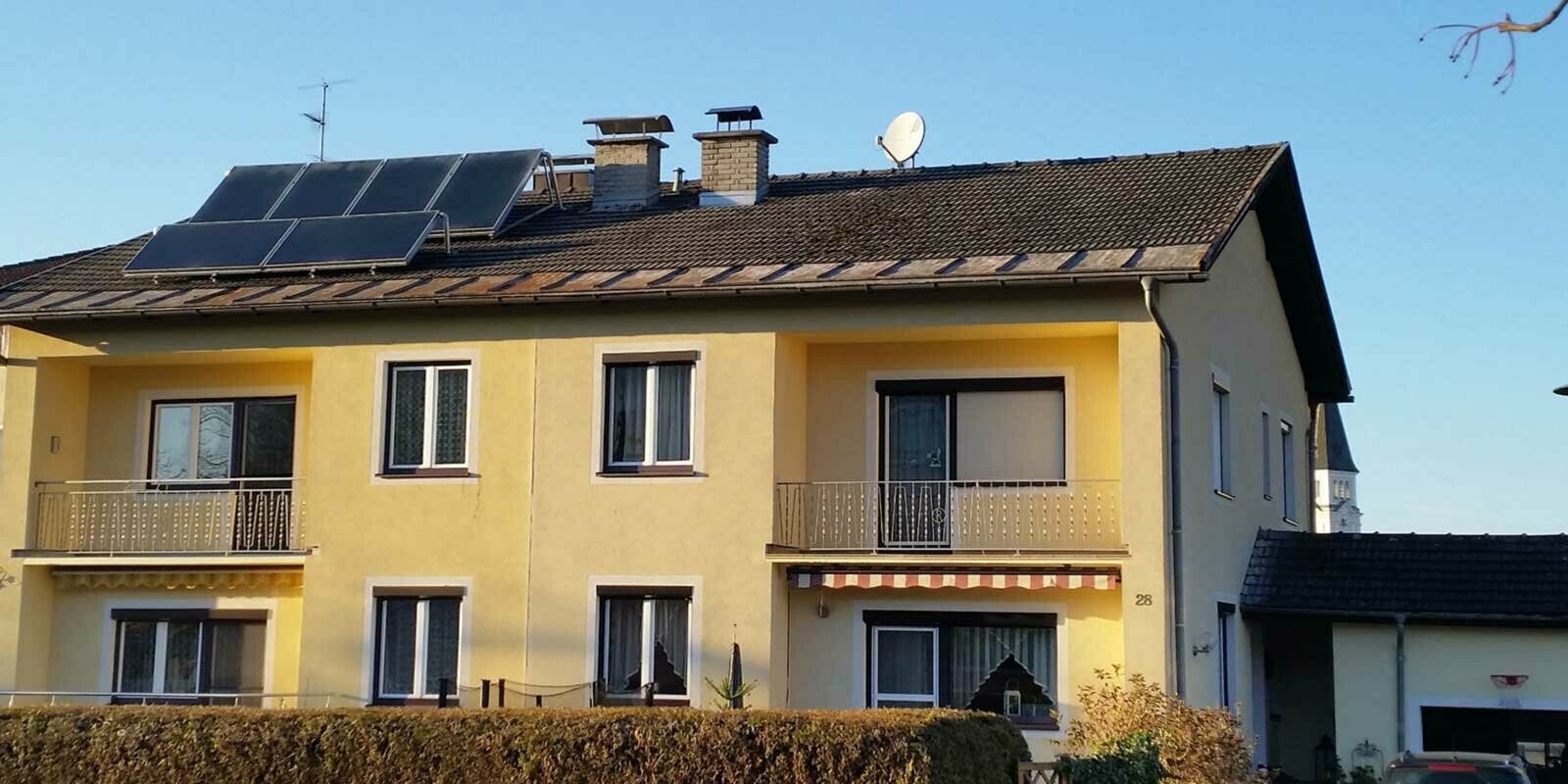 Immeuble d’habitation avant la rénovation de toiture à l’aide de tuiles PREFA, en Autriche