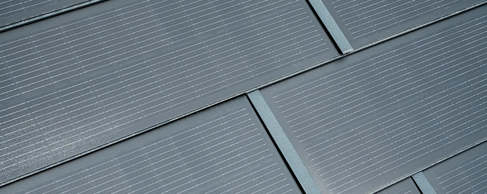 Gros plan de la tuile solaire petit format posée. La tuile solaire petit format couleur P.10 anthracite a été combinée au R.16. 