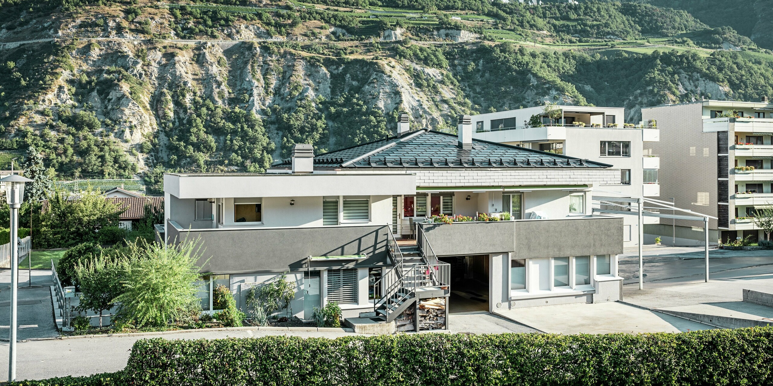 Die Weinkellerei Leukersonne verbindet moderne Architektur mit nachhaltiger Energiegewinnung. Das Zeltdach wurde mit robusten PREFA Dachplatten R.16 und innovativen PREFA Solardachplatten im eleganten P.10 Schwarz eingedeckt. Die integrierten Photovoltaikmodule sorgen für eine nachhaltige Stromerzeugung sowie eine anspruchsvolle Optik. 